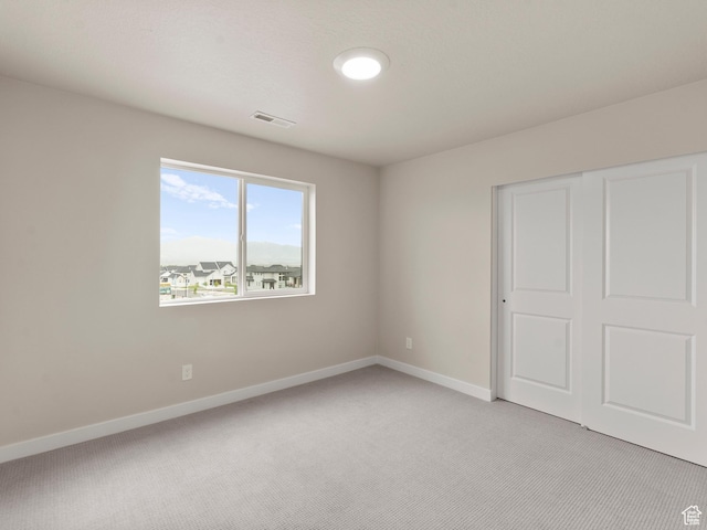 1597 N Cozy Ln Unit 14, Saratoga Springs, UT 84045 - unfurnished bedroom featuring light carpet and a closet