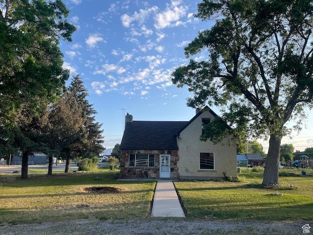 396 W 400 N, Manti, UT 84642 - english style home with stone siding, a chimney, a front lawn, and stucco siding
