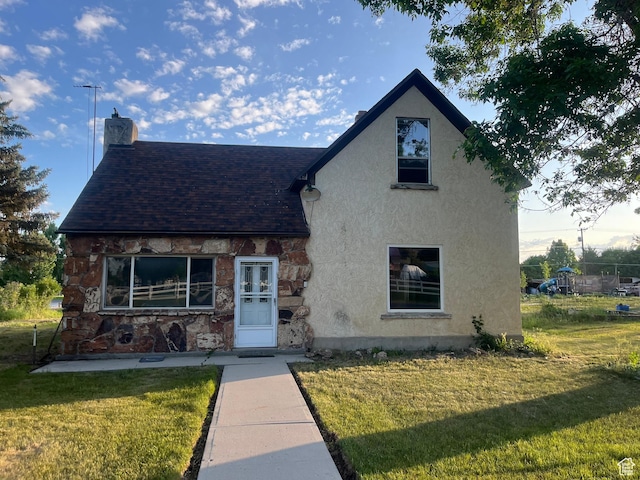 396 W 400 N, Manti, UT 84642 - view of front of property featuring stucco siding, a front yard, a chimney, roof with shingles, and stone siding