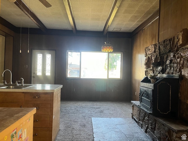 396 W 400 N, Manti, UT 84642 - kitchen with a sink, a wood stove, brown cabinets, carpet, and beam ceiling