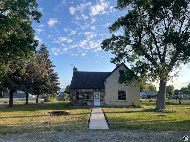 396 W 400 N, Manti, UT 84642 - tudor home featuring stone siding, a front lawn, a chimney, and stucco siding