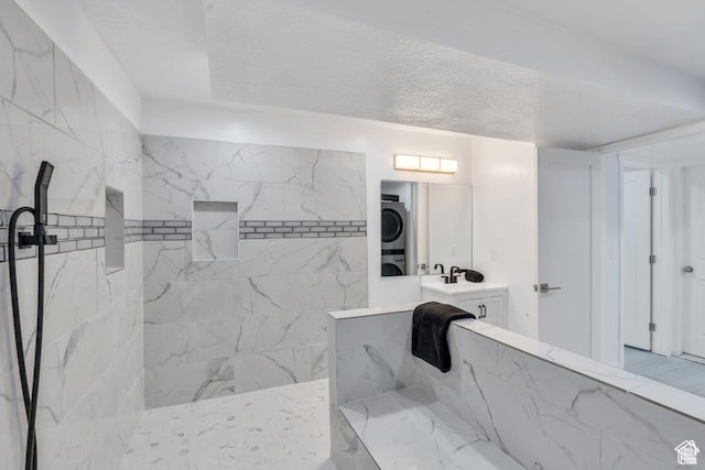 873 S Sunflower Ln W, Mapleton, UT 84664 - bathroom featuring stacked washer / dryer, walk in shower, vanity, and a textured ceiling