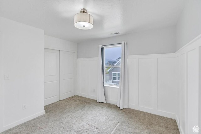 873 S Sunflower Ln W, Mapleton, UT 84664 - unfurnished bedroom featuring carpet floors, a decorative wall, a wainscoted wall, and a closet
