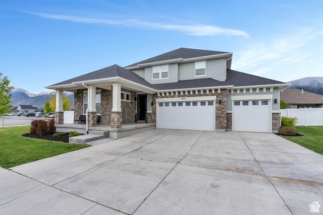 873 S Sunflower Ln W, Mapleton, UT 84664 - prairie-style house featuring a mountain view, stone siding, covered porch, concrete driveway, and a garage