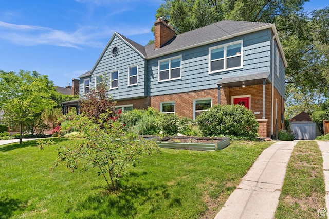 1130 S 1300 E, Salt Lake City, UT 84105 - view of front facade with a front yard, a chimney, brick siding, a garden, and a storage unit