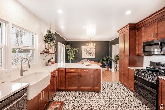 1130 S 1300 E, Salt Lake City, UT 84105 - kitchen featuring stainless steel appliances, a chandelier, a peninsula, light countertops, and recessed lighting