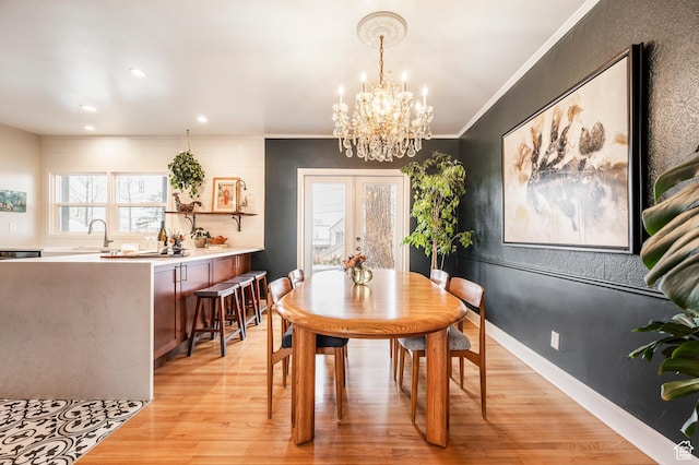 1130 S 1300 E, Salt Lake City, UT 84105 - dining area featuring light wood-style flooring, a chandelier, crown molding, recessed lighting, and french doors
