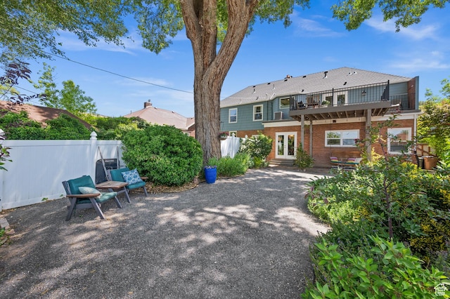 1130 S 1300 E, Salt Lake City, UT 84105 - back of house featuring a balcony, brick siding, a patio area, and french doors