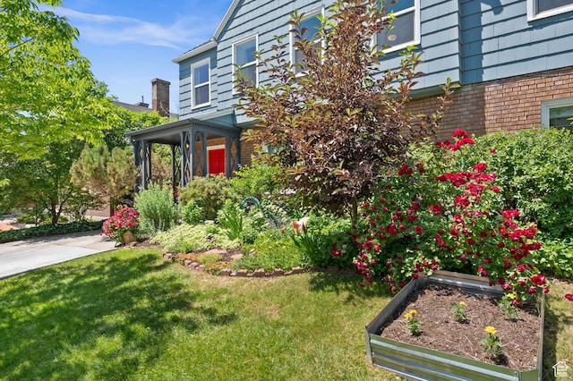 1130 S 1300 E, Salt Lake City, UT 84105 - view of side of home with a yard, brick siding, and a garden