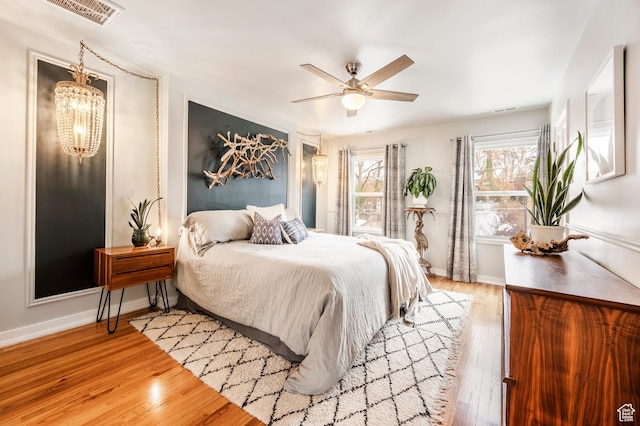 1130 S 1300 E, Salt Lake City, UT 84105 - bedroom featuring light wood-style floors, a chandelier, and ceiling fan