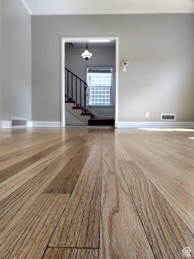 1130 S 1300 E, Salt Lake City, UT 84105 - empty room featuring stairway, wood finished floors, and a chandelier