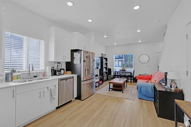 1230 W 1820 S, Logan, UT 84321 - kitchen with appliances with stainless steel finishes, a sink, light wood-type flooring, healthy amount of natural light, and recessed lighting