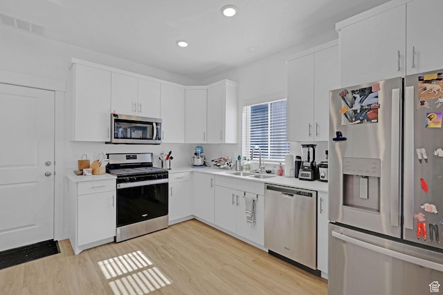 1230 W 1820 S, Logan, UT 84321 - kitchen with appliances with stainless steel finishes, a sink, light wood-type flooring, light countertops, and recessed lighting