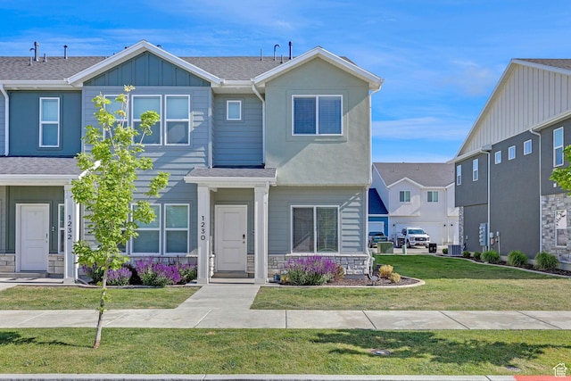 1230 W 1820 S, Logan, UT 84321 - view of front of property featuring board and batten siding, roof with shingles, a front yard, and central AC