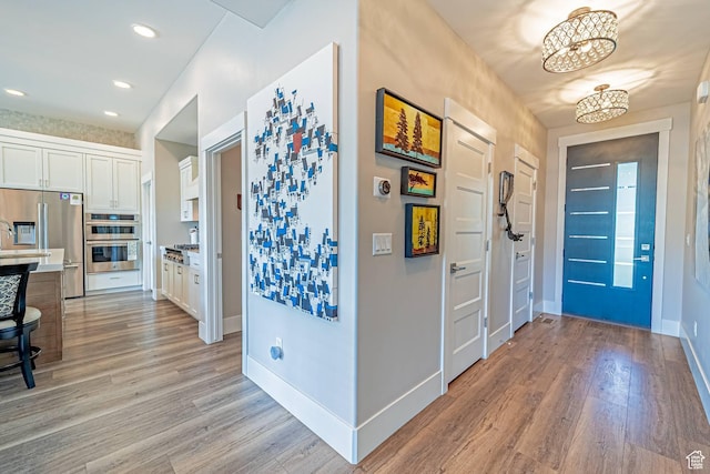 11517 N Perspective Dr, Hideout, UT 84036 - entrance foyer with light wood finished floors, a chandelier, baseboards, and recessed lighting