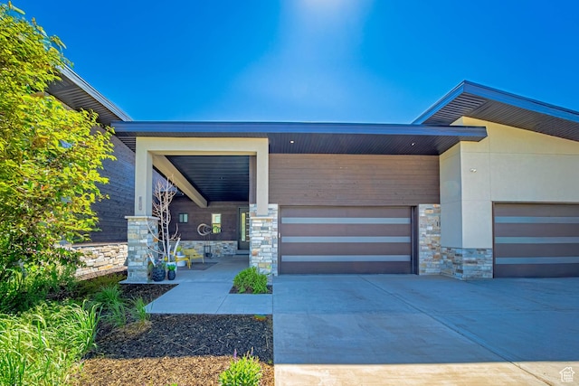 11517 N Perspective Dr, Hideout, UT 84036 - entrance to property featuring stone siding, an attached garage, and concrete driveway