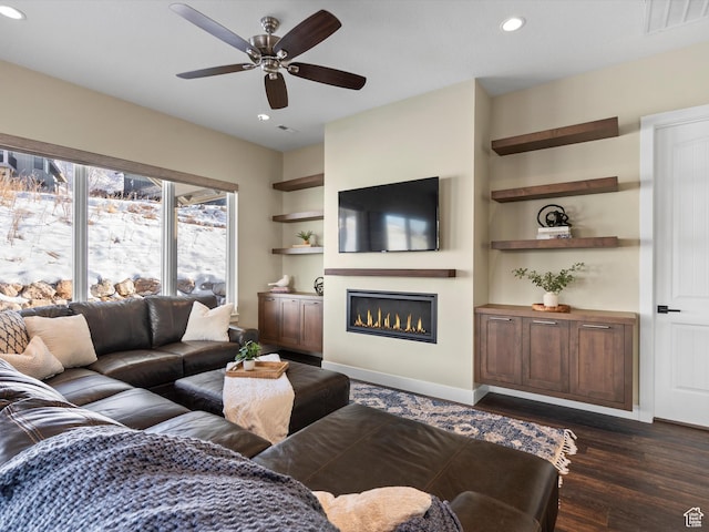 5943 E Big Horn Pkwy, Eden, UT 84310 - living room featuring recessed lighting, a glass covered fireplace, a ceiling fan, dark wood-style flooring, and baseboards