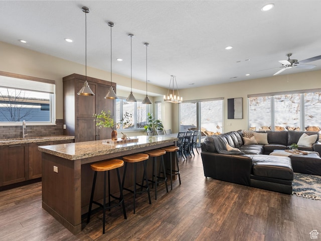 5943 E Big Horn Pkwy, Eden, UT 84310 - kitchen with a sink, a center island, open floor plan, dark wood-style flooring, and recessed lighting