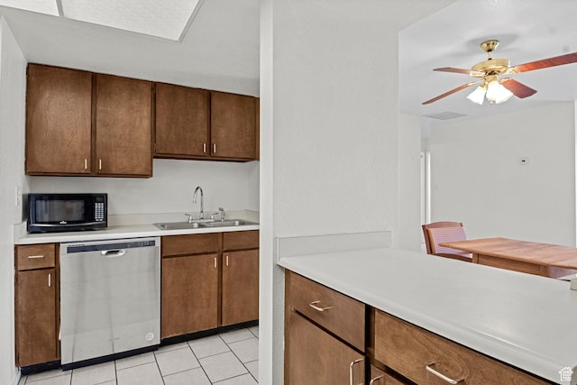 207 S 600 E Unit 3C, Salt Lake City, UT 84102 - kitchen featuring stainless steel dishwasher, black microwave, a sink, light countertops, and light tile patterned floors