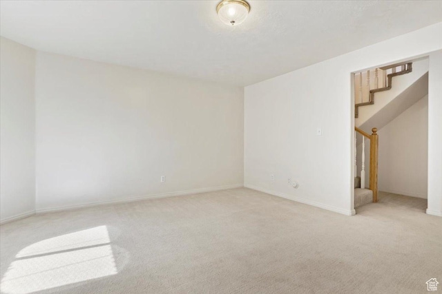 7825 S Spruce Tree Ln, Sandy, UT 84094 - spare room featuring stairway, light carpet, and baseboards