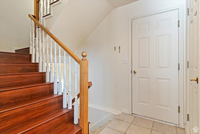 7825 S Spruce Tree Ln, Sandy, UT 84094 - staircase with tile patterned flooring, vaulted ceiling, and baseboards