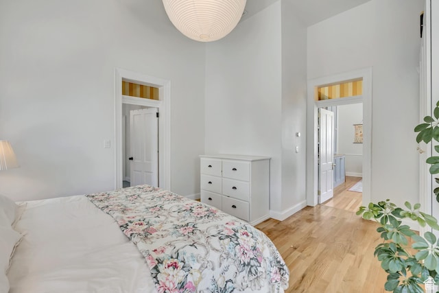 119 E 400 S, Provo, UT 84606 - bedroom featuring light wood-style floors, a towering ceiling, and baseboards