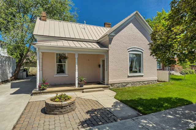 119 E 400 S, Provo, UT 84606 - view of front of home with a chimney, a standing seam roof, brick siding, and a porch