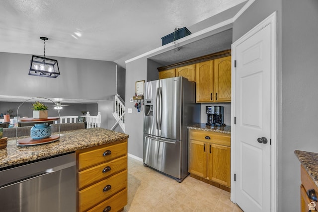 5419 S 4125 W, Roy, UT 84067 - kitchen featuring stainless steel appliances, dark stone countertops, brown cabinetry, and a ceiling fan