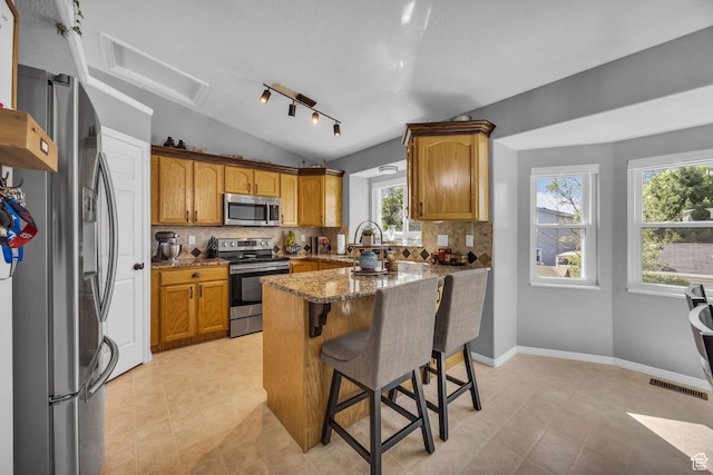 5419 S 4125 W, Roy, UT 84067 - kitchen with appliances with stainless steel finishes, vaulted ceiling, healthy amount of natural light, and backsplash