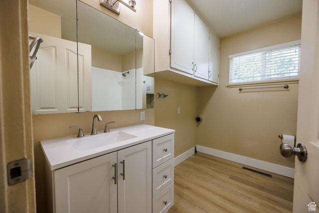 1814 W 80 S, Provo, UT 84601 - washroom with light wood-style floors, baseboards, cabinet space, and washer hookup