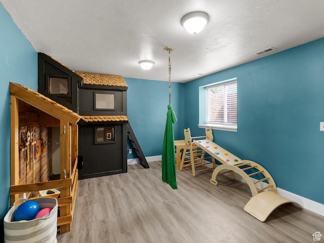1046 W 370 N, Hyrum, UT 84319 - game room with light wood-style flooring and baseboards