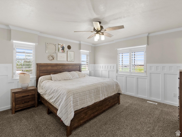 1046 W 370 N, Hyrum, UT 84319 - carpeted bedroom featuring wainscoting, crown molding, multiple windows, a decorative wall, and ceiling fan