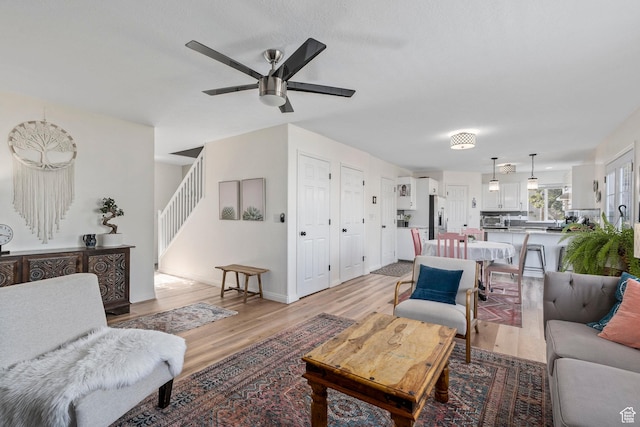 116 S Canyon View Dr, Elk Ridge, UT 84651 - living room with ceiling fan, light wood finished floors, stairway, and baseboards