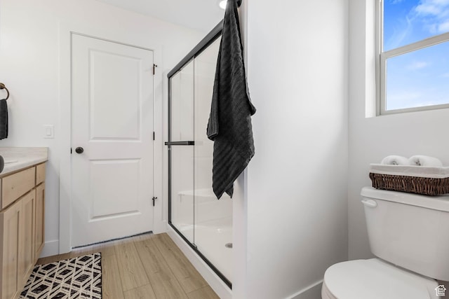 606 W Caroles Way, Tooele, UT 84074 - bathroom with a stall shower, toilet, vanity, and wood finished floors