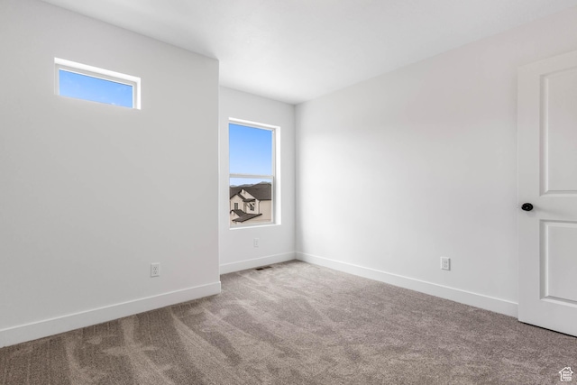 606 W Caroles Way, Tooele, UT 84074 - spare room featuring carpet floors, plenty of natural light, and baseboards