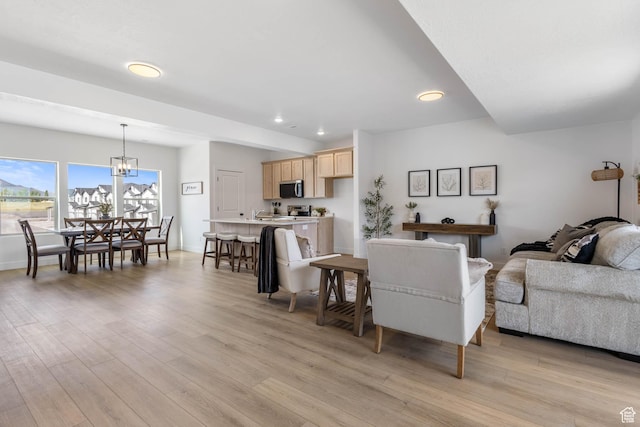 606 W Caroles Way, Tooele, UT 84074 - living room featuring light wood-style floors, recessed lighting, a chandelier, and baseboards