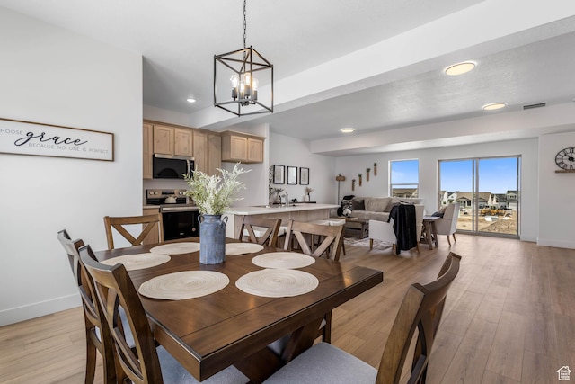 606 W Caroles Way, Tooele, UT 84074 - dining area featuring baseboards, light wood finished floors, a chandelier, and recessed lighting
