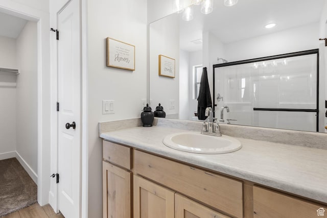 606 W Caroles Way, Tooele, UT 84074 - full bath featuring vanity, an enclosed shower, a closet, and wood finished floors