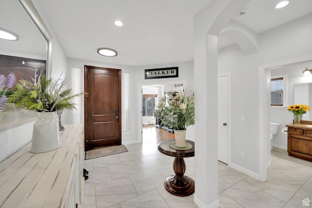 14789 S Briar Park Rd W, Herriman, UT 84096 - foyer with arched walkways, light marble finish floors, and baseboards
