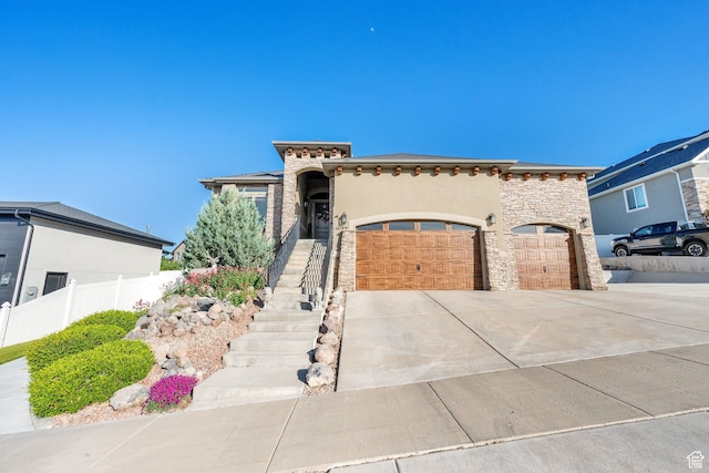 14789 S Briar Park Rd W, Herriman, UT 84096 - view of front of home with concrete driveway, a garage, stone siding, and stucco siding