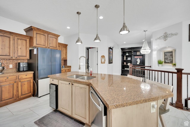 14789 S Briar Park Rd W, Herriman, UT 84096 - kitchen featuring a sink, stainless steel appliances, light stone counters, decorative backsplash, and an island with sink