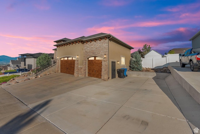 14789 S Briar Park Rd W, Herriman, UT 84096 - view of front of property featuring stone siding, concrete driveway, and a garage