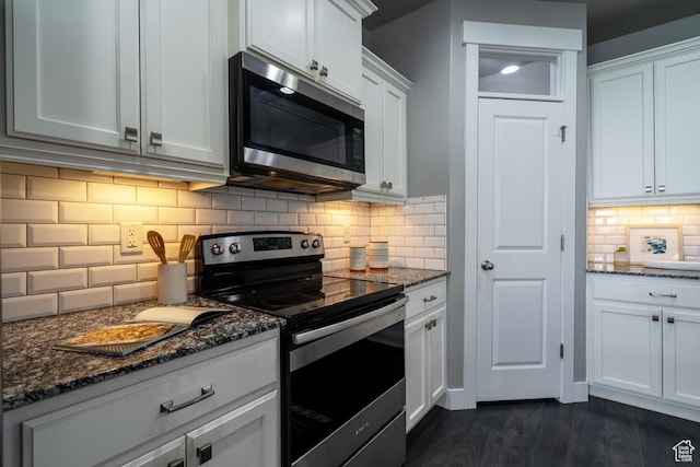 14508 S Juniper Shade Dr W, Herriman, UT 84096 - kitchen with appliances with stainless steel finishes, decorative backsplash, dark stone counters, and white cabinetry