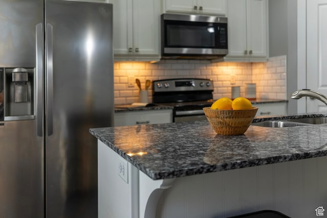 14508 S Juniper Shade Dr W, Herriman, UT 84096 - kitchen featuring stainless steel appliances, a sink, dark stone countertops, and tasteful backsplash