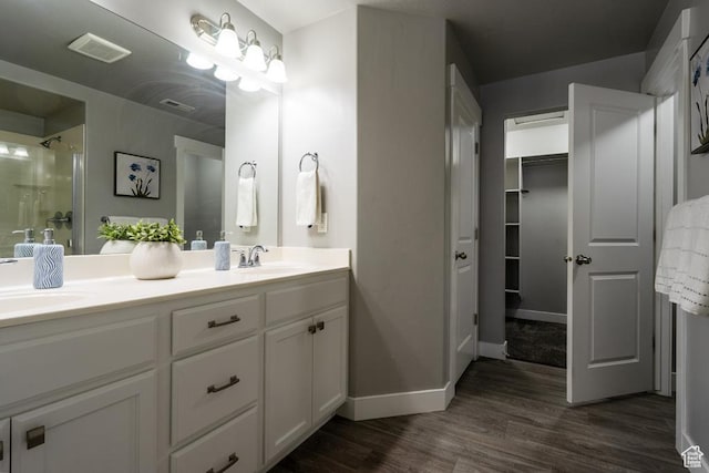 14508 S Juniper Shade Dr W, Herriman, UT 84096 - full bath featuring double vanity, wood finished floors, an enclosed shower, baseboards, and a walk in closet