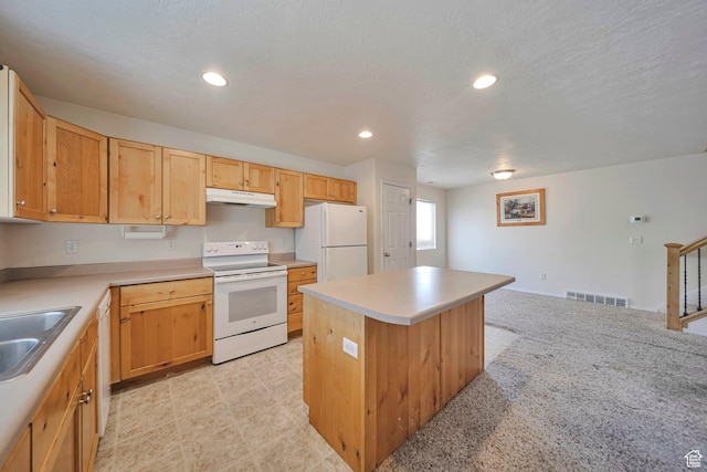 1588 N Dawson W, Tooele, UT 84074 - kitchen featuring white appliances, a sink, under cabinet range hood, a center island, and light countertops