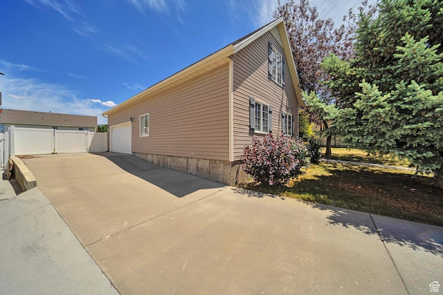 1588 N Dawson W, Tooele, UT 84074 - view of property exterior with an attached garage and driveway