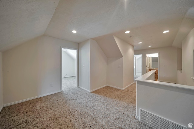1588 N Dawson W, Tooele, UT 84074 - additional living space with lofted ceiling, light carpet, recessed lighting, baseboards, and a textured ceiling