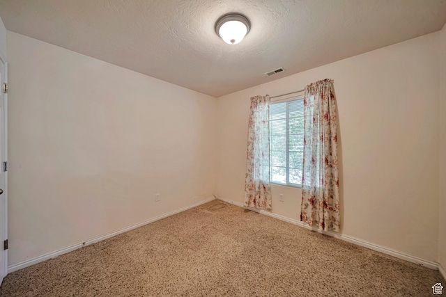 1588 N Dawson W, Tooele, UT 84074 - spare room featuring light colored carpet, baseboards, and a textured ceiling