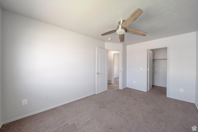 1454 N 420 E, Tooele, UT 84074 - unfurnished bedroom featuring light colored carpet, a ceiling fan, a spacious closet, baseboards, and a closet